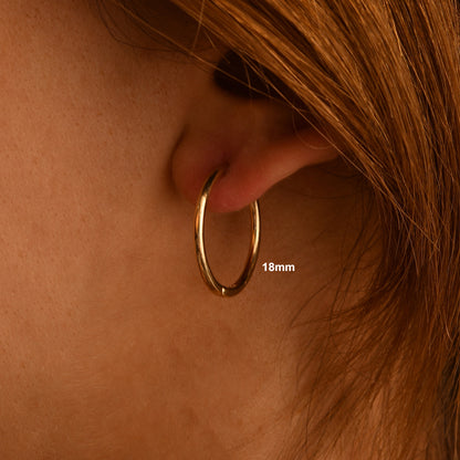 These handmade solid gold hoop earrings are designed for effortless everyday wear.