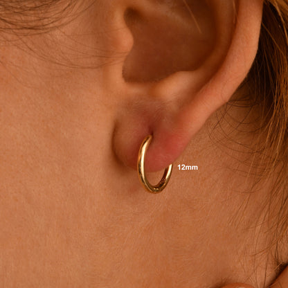 These handmade solid gold hoop earrings are designed for effortless everyday wear.