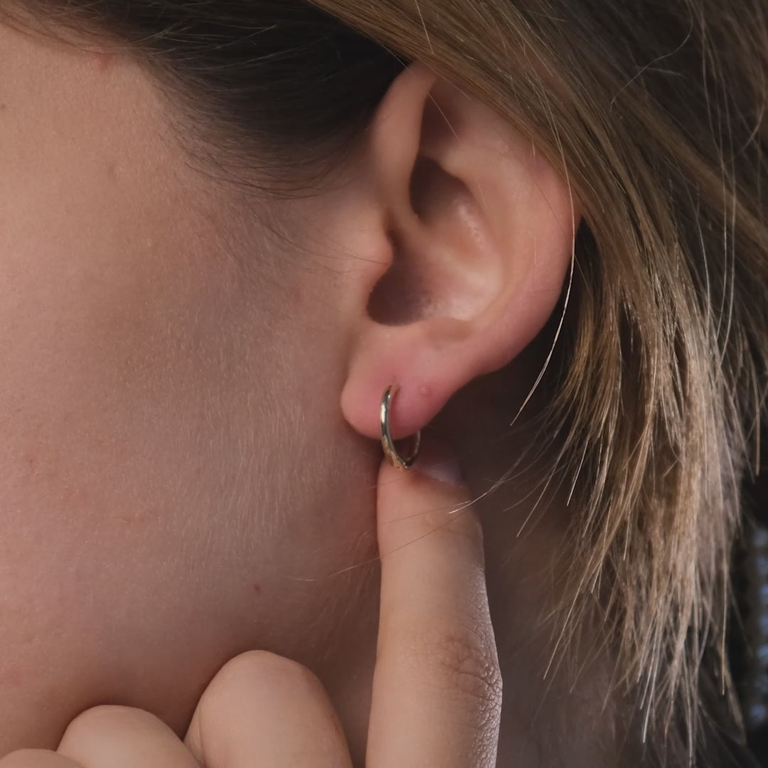 These handmade solid gold hoop earrings are designed for effortless everyday wear.